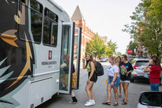 Students in line boarding a IUK bus.